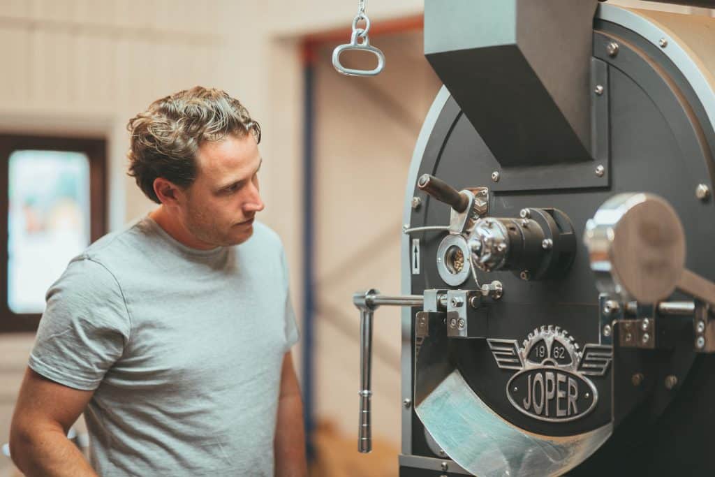 Conker Coffee Liqueur coffee beans being roasted in a coffee roaster.